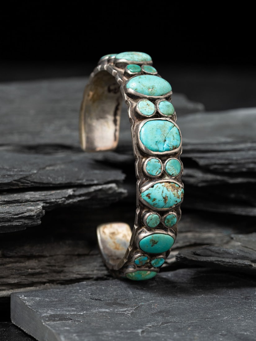 Navajo Turquoise Cluster Cuff Bracelet, Collected by Hoffman Birney (1891-1958): Navajo Turquoise Cluster Cuff Bracelet, Collected by Hoffman Birney (1891-1958) first quarter 20th century larger oval turquoise stones alternating with stacked circular stones cuff width 5/8 inch, in