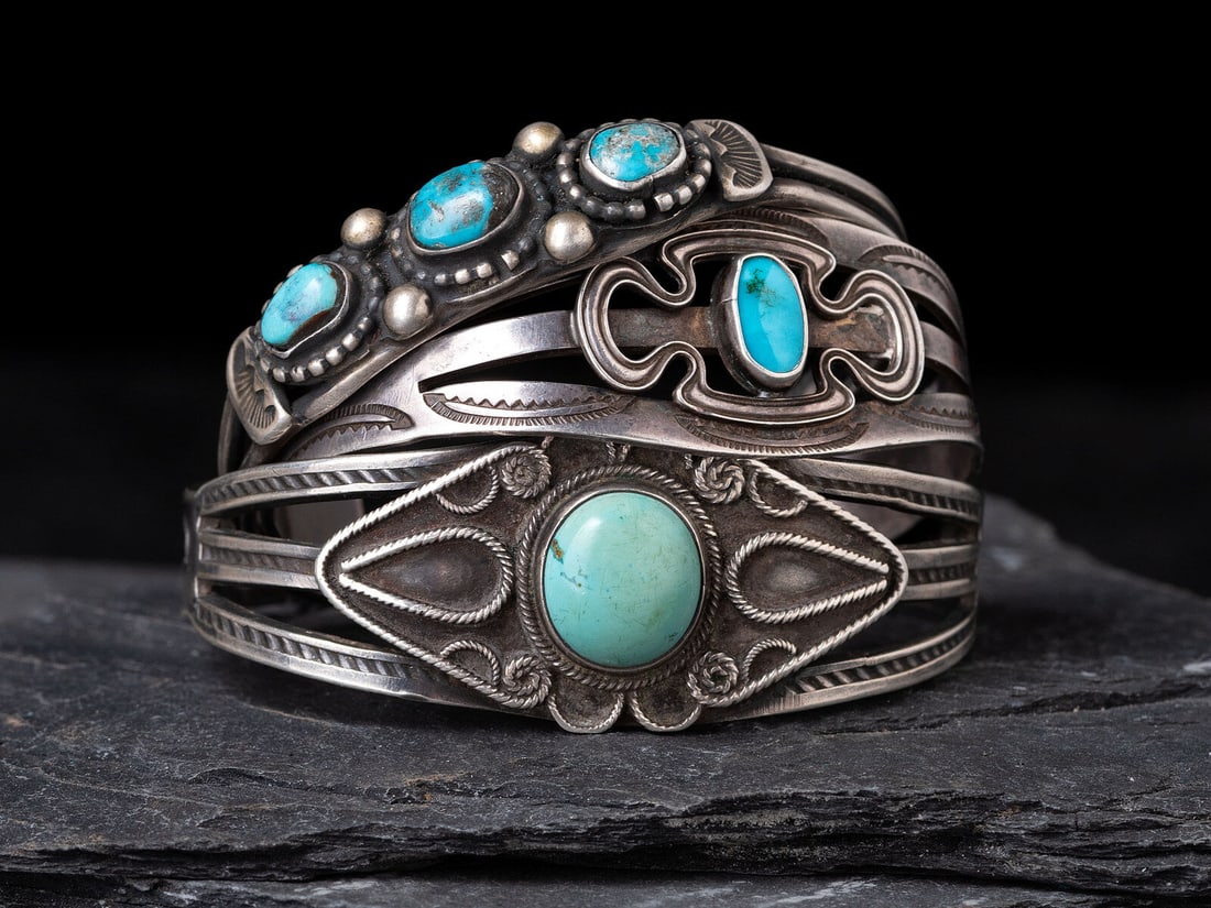 Navajo Silver and Turquoise Cuff Bracelets: Navajo Silver and Turquoise Cuff Bracelets first half 20th century lot of 3, includes: a split shank ingot example with heavy stamping and set with a single turquoise cabochon; not marked cuff width 7