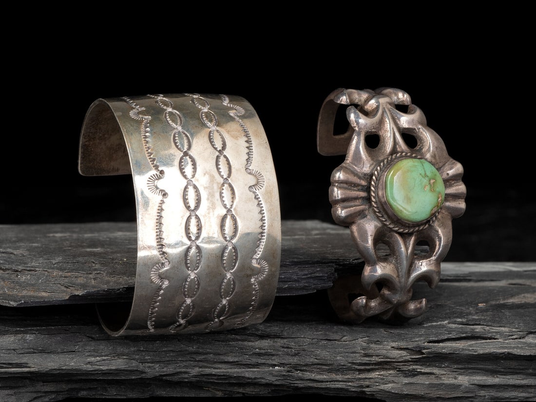 Pair of Navajo Cuff Bracelets: Pair of Navajo Cuff Bracelets third quarter 20th century lot of 2, includes: a wide stamped example; marked STERLING JH cuff width 1-1/2 inches, interior circumference 6 inches + gap length 1-3/8 inch