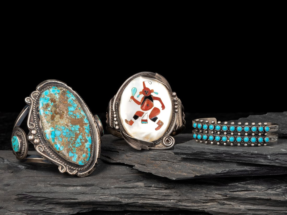 Navajo and Zuni Silver Cuff Bracelets with Inlay: Navajo and Zuni Silver Cuff Bracelets with Inlay third quarter 20th century lot of 3, includes: an unmarked cuff with large turquoise nugget cuff width 3-1/4 inches, interior circumference 5-3/4 inche