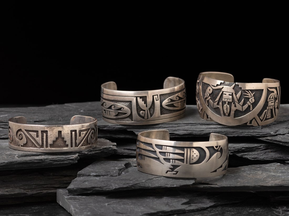 Hopi Silver Overlay Cuff Bracelets: Hopi Silver Overlay Cuff Bracelets late 20th - early 21st century lot of 4, includes: one with migration pattern offset with geometrics; marked with hallmark of Norman Honie, Sr. cuff width 3/4 inch,