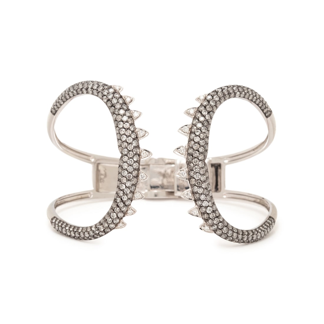 STEPHEN WEBSTER, WHITE GOLD AND DIAMOND 'SHARK JAW' CUFF BRACELET: STEPHEN WEBSTER, WHITE GOLD AND DIAMOND 'SHARK JAW' CUFF BRACELET Round brilliant cut white and gray diamonds weighing approximately 4.50 carats total, hinged at the back. 18 karat white gold. 6 1/2 i