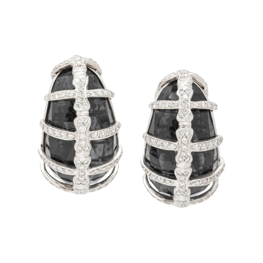 STEPHEN WEBSTER, HEMATITE, QUARTZ AND DIAMOND 'JULES VERNE' EARRINGS: STEPHEN WEBSTER, HEMATITE, QUARTZ AND DIAMOND 'JULES VERNE' EARRINGS Hematite surmounted by faceted quartz and round brilliant cut diamonds. 18 karat white gold. 1 inch long. Stamp: SW 750 18K 133 (ma