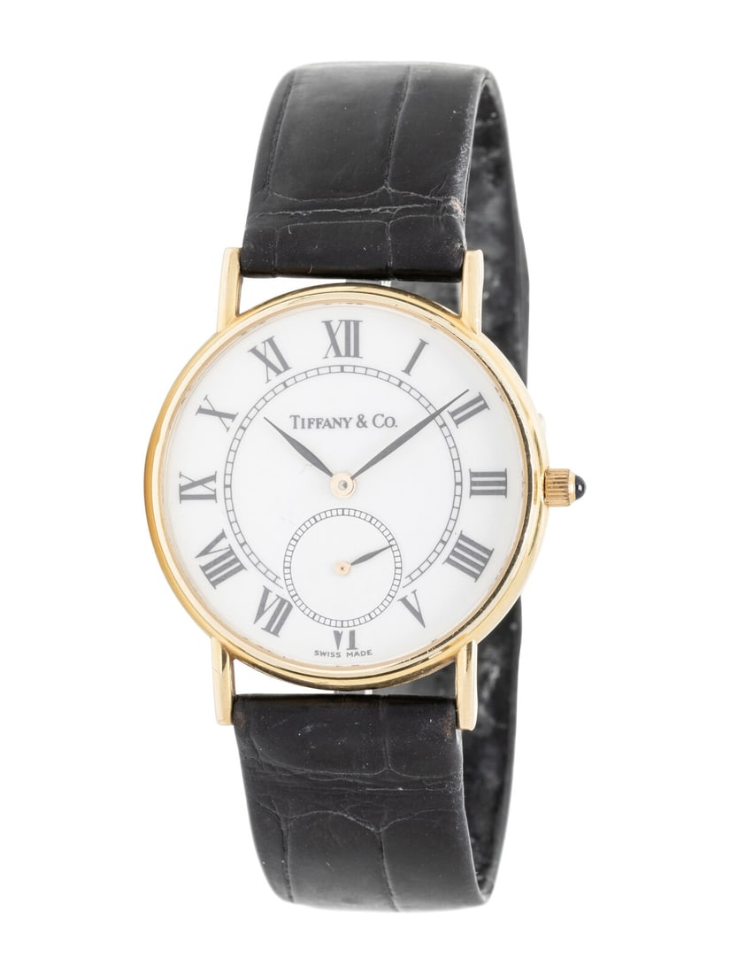 TIFFANY & CO., 14K YELLOW GOLD WATCH: TIFFANY & CO., 14K YELLOW GOLD WATCH Maker: Tiffany & Company Serial number: 970270541 Year: Circa 2001 Case size: Approx. 31 mm Case material: 14K yellow gold Dial: White Movement: Quartz Bra
