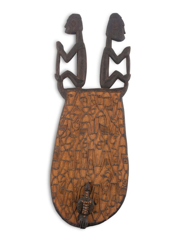 An Asmat Carved Wood Shield: An Asmat Carved Wood Shield Height 29 1/4 x width 10 1/2 inches. This lot is located in Chicago. Property from a Private Estate, Cleveland, Ohio