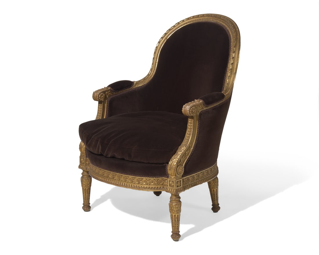 A Louis XVI style giltwood bergere, probably 19th century: A Louis XVI style giltwood bergère, probably 19th century Upholstered in Holly Hunt chocolate velvet. H: 37 1/2 in. W: 25 in. D: 27 in. (overall), H: 17 in. (seat height) This lot is located in Phila