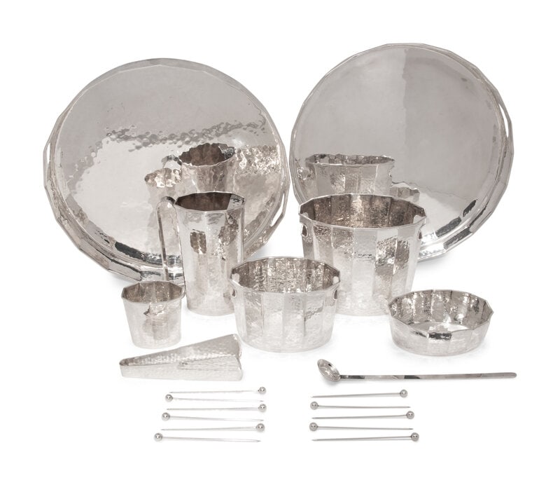 A Set of Italian Hand Hammered Silver-Plate Table Articles: A Set of Italian Hand Hammered Silver-Plate Table Articles Cassetti, Florence, Second Half 20th Century comprising a pair of silver trays, two ice buckets (of varying size), tongs, a pitcher, a small