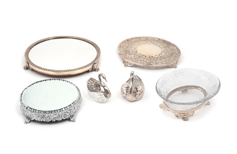 A Group of Silver and Silver-Plate Mounted Articles: A Group of Silver and Silver-Plate Mounted Articles 20th Century comprising a silver-plate and mirror table plateau, Pairpoint Mfg. Co.; a silver-mounted glass trivet; a silver-plate mounted cut glass