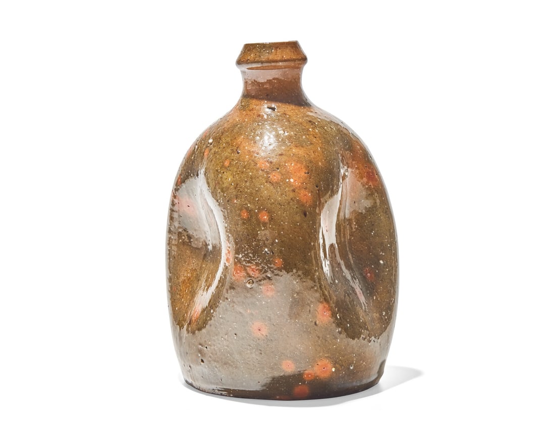 A Gonic-Glazed Pinch Form Redware Bottle, New England, 19th Century: A Gonic-Glazed Pinch Form Redware Bottle, New England, 19th Century Of ovoid form. H: 7 in. This lot is located in Philadelphia. The Collection of Dr. Richard J. and Eva Wattenmaker, Pennsylvania