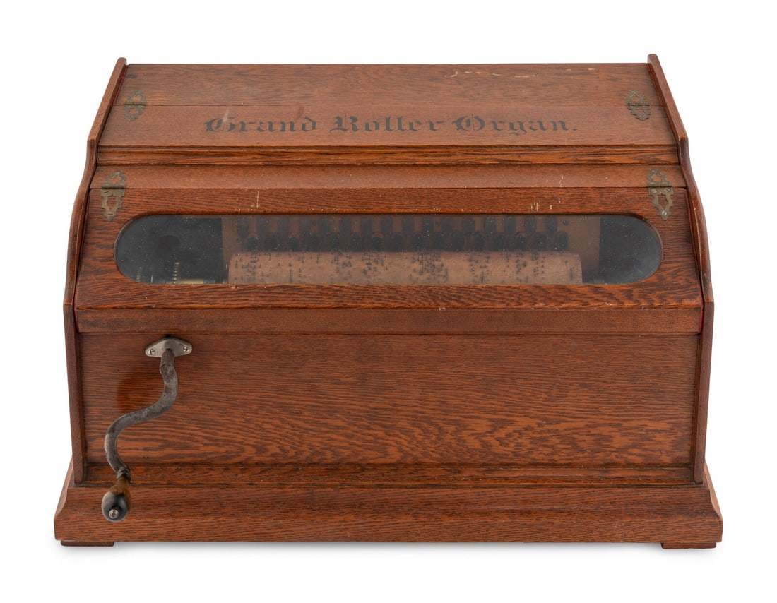 A Grand Roller Organ: A Grand Roller Organ American, Late 19th Century with 32-key mechanism, oak case and five original and reproduction cobs. Height of case 13 1/2 x width 26 x depth 16 inches. This lot is located in Chi