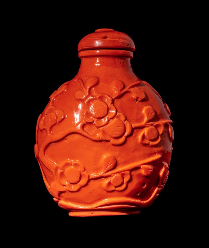 A Chinese Glass Imitating Red Coral 'Prunus' Snuff Bottle: A Chinese Glass Imitating Red Coral 'Prunus' Snuff Bottle 20th Century of ovoid form, carved to the exterior with continuous prunus branches. Overall height 3 inches, 7.6 cm. This lot is