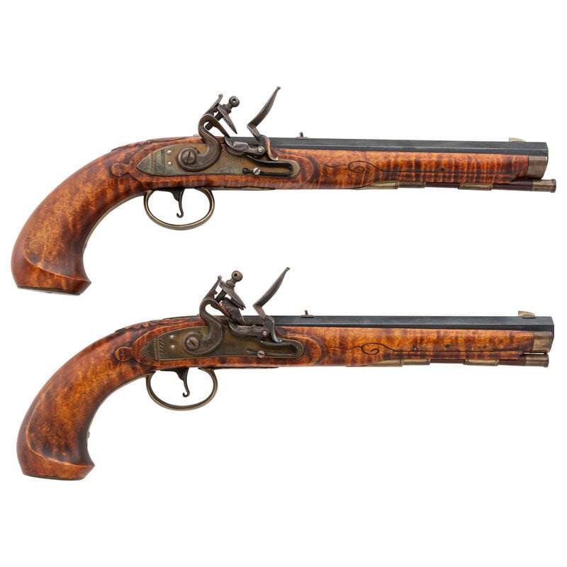 Pair of Contemporary .45 Caliber Flintlock Pistols by L.D. Norris: Pair of Contemporary .45 Caliber Flintlock Pistols by L.D. Norris .45. 9" barrel length. SN: NSN. Blued barrels with brass furnishings, tinted locks, and set in curly maple stocks with pineapple finia