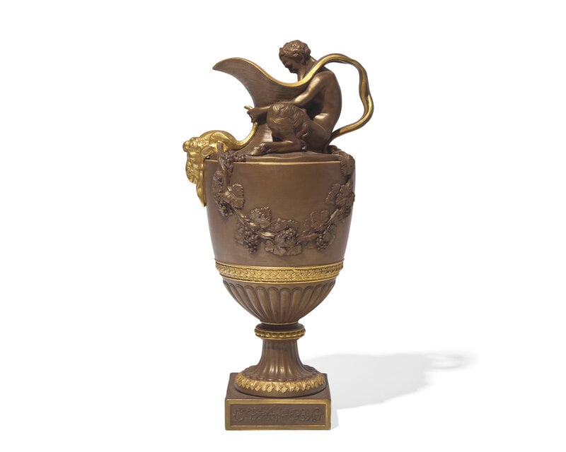 A Wedgwood Parcel Gilt Bronzed Black Basalt Wine Ewer: A Wedgwood Parcel Gilt Bronzed Black Basalt Wine Ewer Circa 1880 impressed Wedgwood to underside. Height 15 1/4 inches. Property from the Collection of Dr. Ellis F. Rubin and