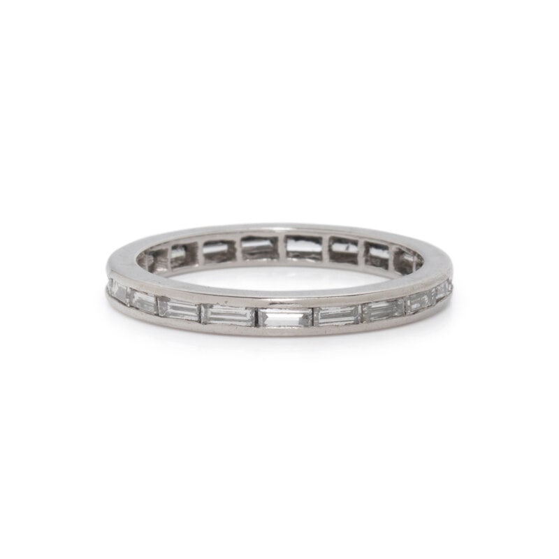 PLATINUM AND DIAMOND ETERNITY BAND: PLATINUM AND DIAMOND ETERNITY BAND Baguette cut diamonds weighing approximately 1.00 carat total. Platinum. Ring size 5. Gross weight: 1.50 dwt. Condition Overall Condition: