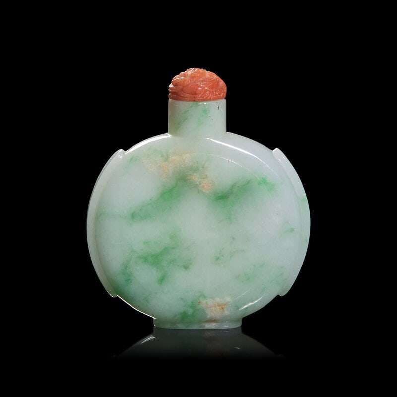 A Chinese Carved Jadeite Flask Form Snuff Bottle: A Chinese Carved Jadeite Flask Form Snuff Bottle Of Bianhu form, the stone of white with veins and infusions of green, coral glass molded stopper button. Height including stopper 2 7/1