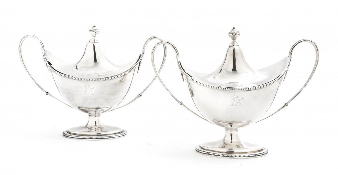 A Pair of George III Silver Covered Sauce Tureens,: A Pair of George III Silver Covered Sauce Tureens, Hester Bateman, London, 1784, each having an urn form finial over the conforming body with applied handles and oval foot; approximate weight 42.42 oz