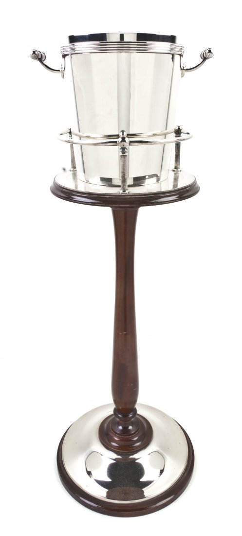 A French Silverplate Champagne Bucket on Stand, Ch: A French Silverplate Champagne Bucket on Stand, Christofle, the bucket of tapering cylindrical form with ringed decoration and applied handles, raised on a turned silverplate mounted mahogany base. He