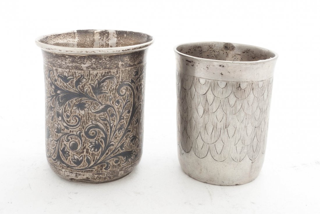 A Pair of Russian Silver Beakers, Height 1 5/8 inc: A Pair of Russian Silver Beakers, each of cylindrical form with a flared lip and Cyrillic hallmarks, one having niello decoration; approximate total weight 4.90 ozt. Height 1 5/8 inches. Property from
