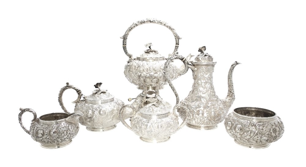 An American Sterling Silver Tea and Coffee Service: An American Sterling Silver Tea and Coffee Service, S. Kirk & Son Inc., each having allover repousse floral decoration, comprising a teapot, a coffee pot, and a kettle on stand with ivory insulators, 
