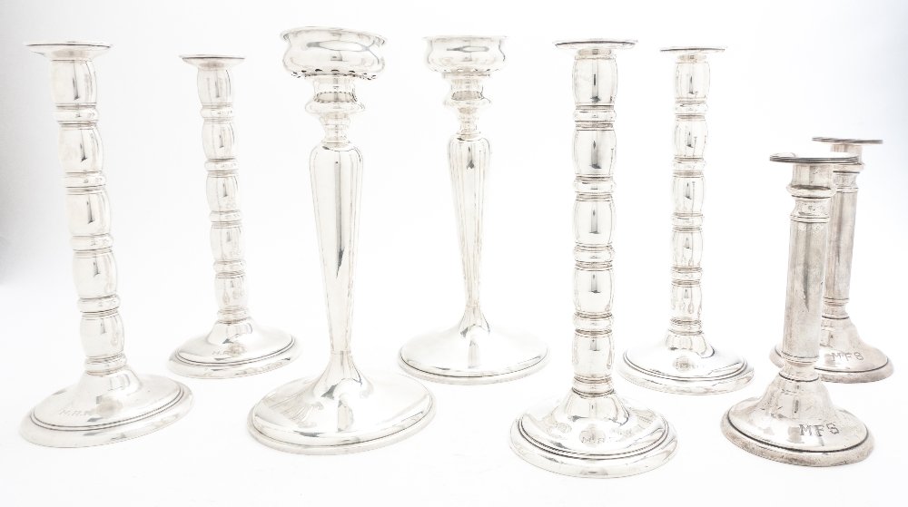 A Set of Four American Sterling Silver Candlestick: A Set of Four American Sterling Silver Candlesticks, Lunt, having a repeating barrel form standard, together with a smaller associated pair and a pair of baluster form candlesticks by J. E. Blake Co.,