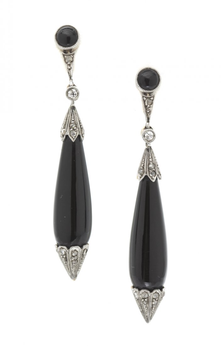 A Pair of Edwardian Platinum Topped Yellow Gold, On: A Pair of Edwardian Platinum Topped Yellow Gold, Onyx and Diamond Earrings, consisting of two bezel set round cabochon cut onyx measuring approximately 4.00 mm in diameter suspending a hinged drop con