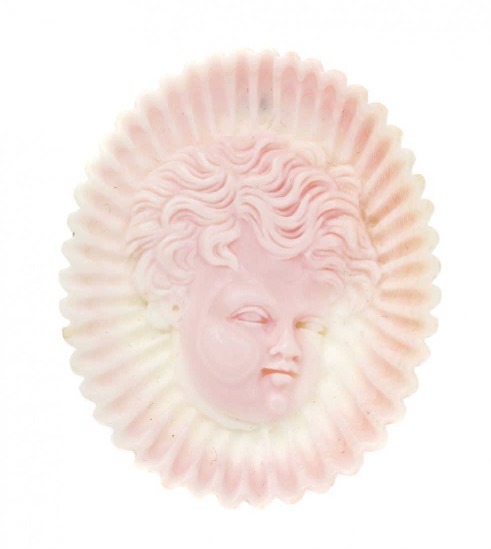 A 14 Karat Yellow Gold and Conch Shell Cameo Pendan: A 14 Karat Yellow Gold and Conch Shell Cameo Pendant/Brooch, consisting of a conch shell cameo depicting a cherub within scalloped border, collapsible bail for use as pendant. Stamp: 14K. 12.00 dwts.