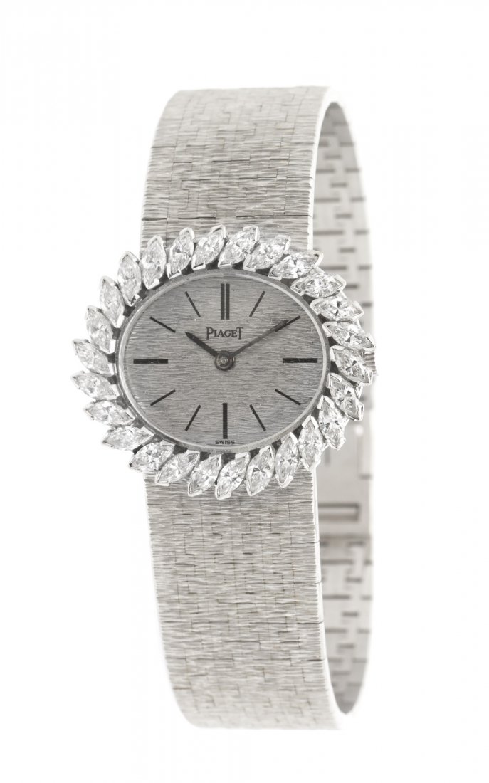 An 18 Karat White Gold and Diamond Wristwatch, Pia: An 18 Karat White Gold and Diamond Wristwatch, Piaget, 30.00 x 26.00 mm case dimensions, bezel contains 26 marquise cut diamonds weighing approximately 4.25 carats total, textured white gold dial, bat