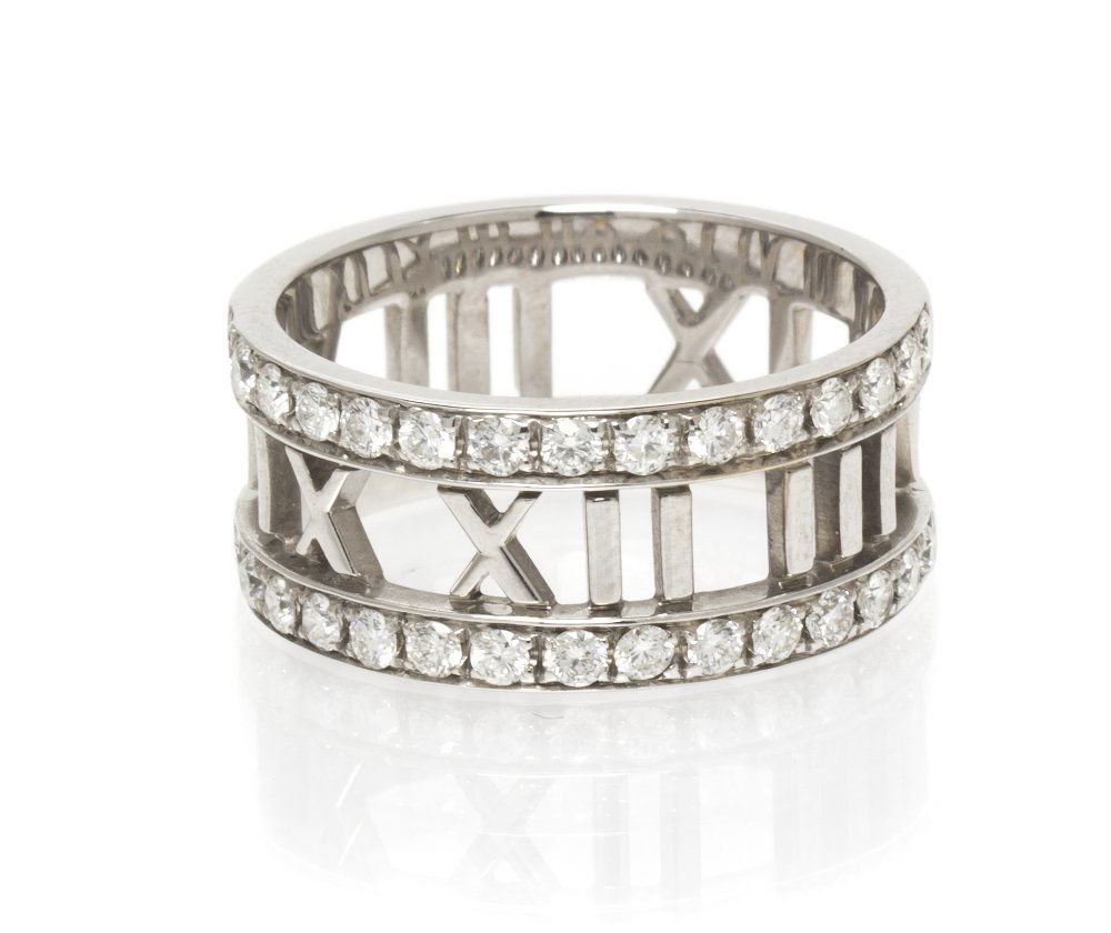 An 18 Karat White Gold and Diamond Atlas Ring, Tif: An 18 Karat White Gold and Diamond Atlas Ring, Tiffany & Co., containing 30 round brilliant cut diamonds weighing approximately 0.60 carat total with pierced work Roman numerals. Stamp: ATLAS 2003 TIF