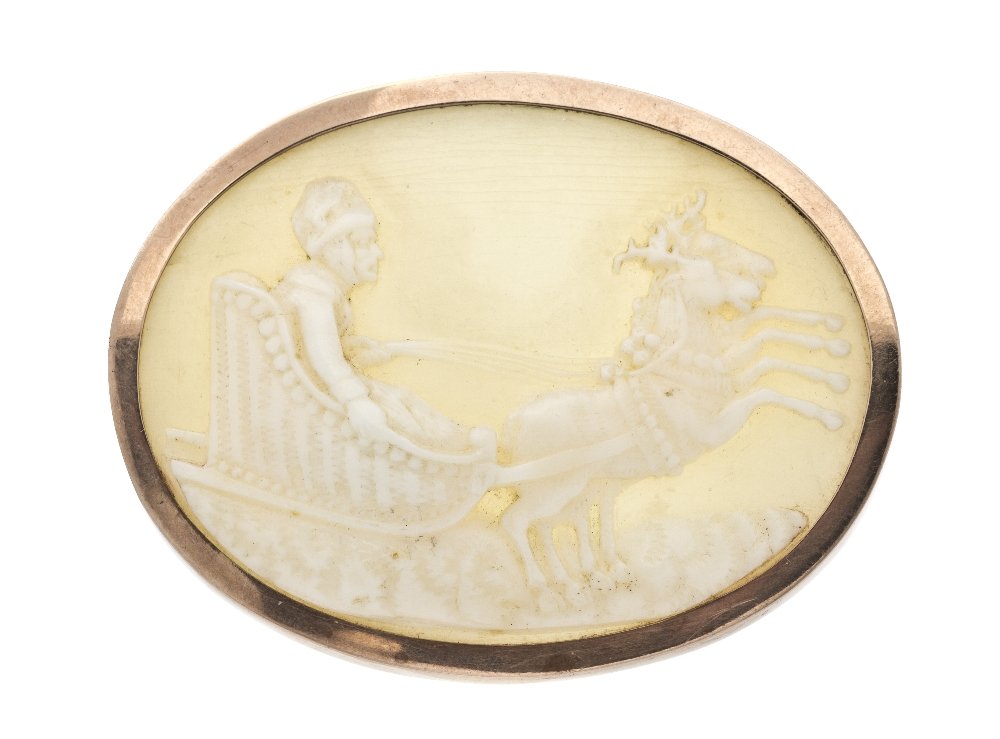 A Yellow Gold and Shell Cameo Brooch,: A Yellow Gold and Shell Cameo Brooch, depicting a male figure in a sleigh being pulled by reindeer, measuring approximately 50.00 x 39.00 mm.