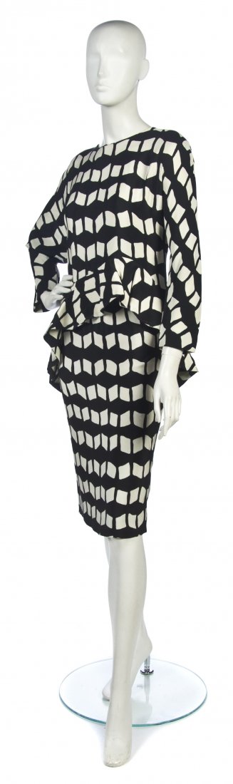 A Black and Cream Geometric Printed Silk Daywear E: A Black and Cream Geometric Printed Silk Daywear Ensemble, attributed to Pierre Cardin, blouse with ruffled high-low hem. Property from the Estate of the Marquise de Surian