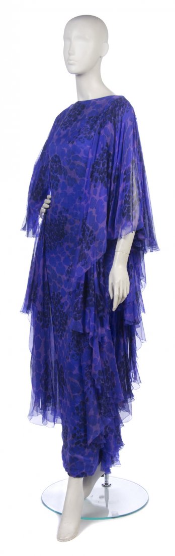 A Purple Floral Printed Chiffon Evening Gown,: A Purple Floral Printed Chiffon Evening Gown, attributed to Pierre Cardin, tiered ruffle chiffon layers to side and back. Property from the Estate of the Marquise de Surian