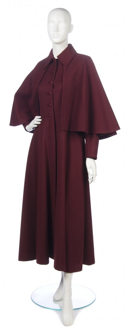 An Yves Saint Laurent Maroon Wool Cape Coat. Size : An Yves Saint Laurent Maroon Wool Cape Coat. Labeled: Saint Laurent. Size 38.