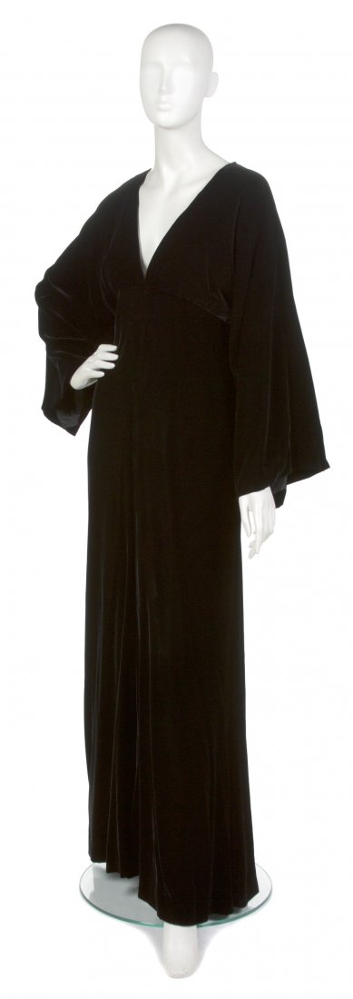 An Oscar de la Renta Black Velvet Evening Gown,: An Oscar de la Renta Black Velvet Evening Gown, bell sleeves, empire waist, keyhole back. Labeled: Oscar de la Renta / Elizabeth Arden.