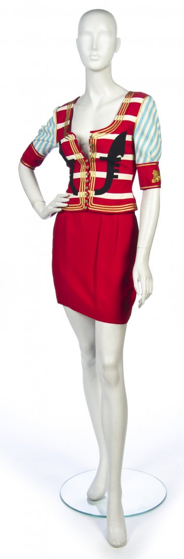 A Moschino Couture! Cruise Me Baby Venice Silk Ski: A Moschino Couture! Cruise Me Baby Venice Silk Skirt Suit, 2000, in an officer motif, cropped jacket in multi-colored with gold ball buttons, gold piping and embellishments, straight skirt in solid re