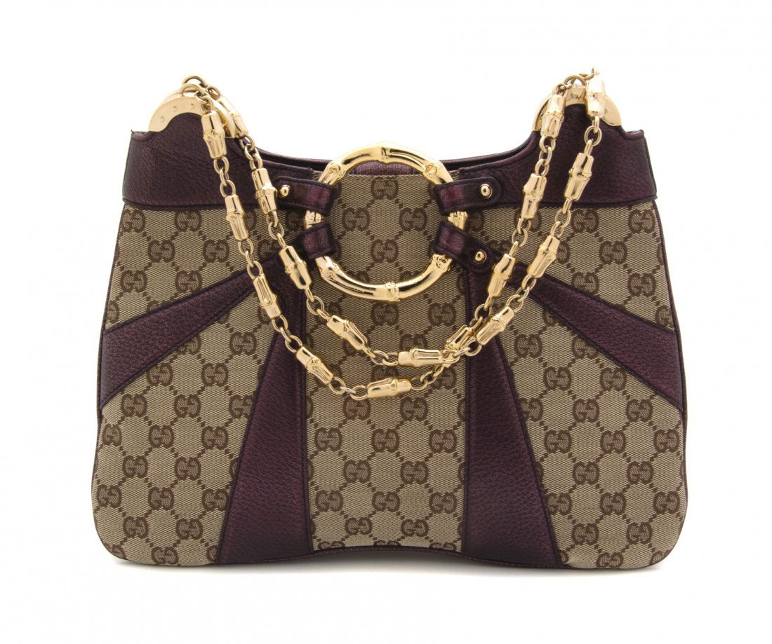 A Gucci Tan Monogram Canvas Bag, 12 1/2 x 8 1/4 x: A Gucci Tan Monogram Canvas Bag, Tom Ford for Gucci, metallic plum leather trim, goldtone bamboo detail at front and shoulder straps, one interior pocket, tonal fabric lining. Stamped: Gucci. 12 1/2 x