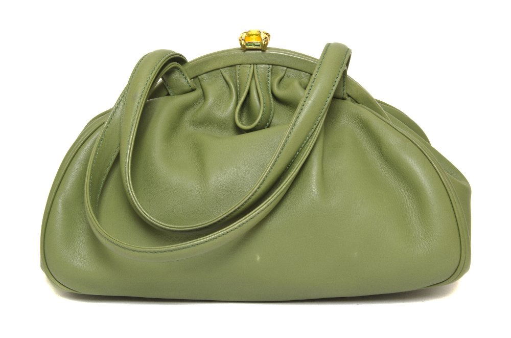 A Judith Leiber Green Leather Purse, 11 x 7 1/2 in: A Judith Leiber Green Leather Purse, with jeweled closure. Labeled: Judith Leiber. 11 x 7 1/2 inches. Property of a Lady, Minneapolis, Minnesota