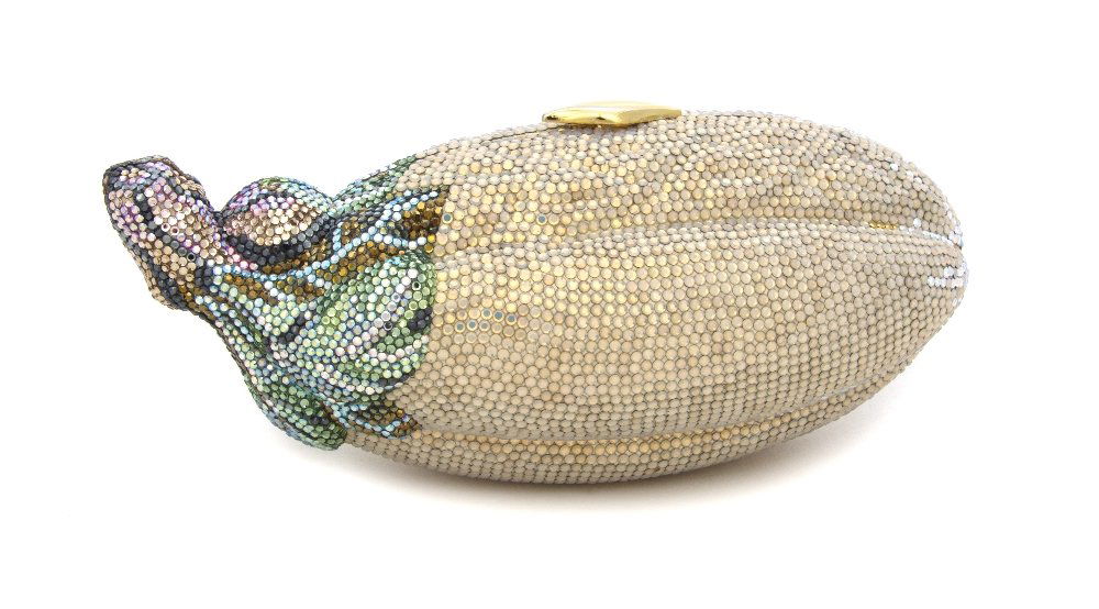 A Judith Leiber Crystal Eggplant Minaudiere,: A Judith Leiber Crystal Eggplant Minaudiere, white iridescent crystals with multicolor crystals as the stem, goldtone leaf push clasp, goldtone hardware, chainlink hidden shoulder strap, gold kid leat