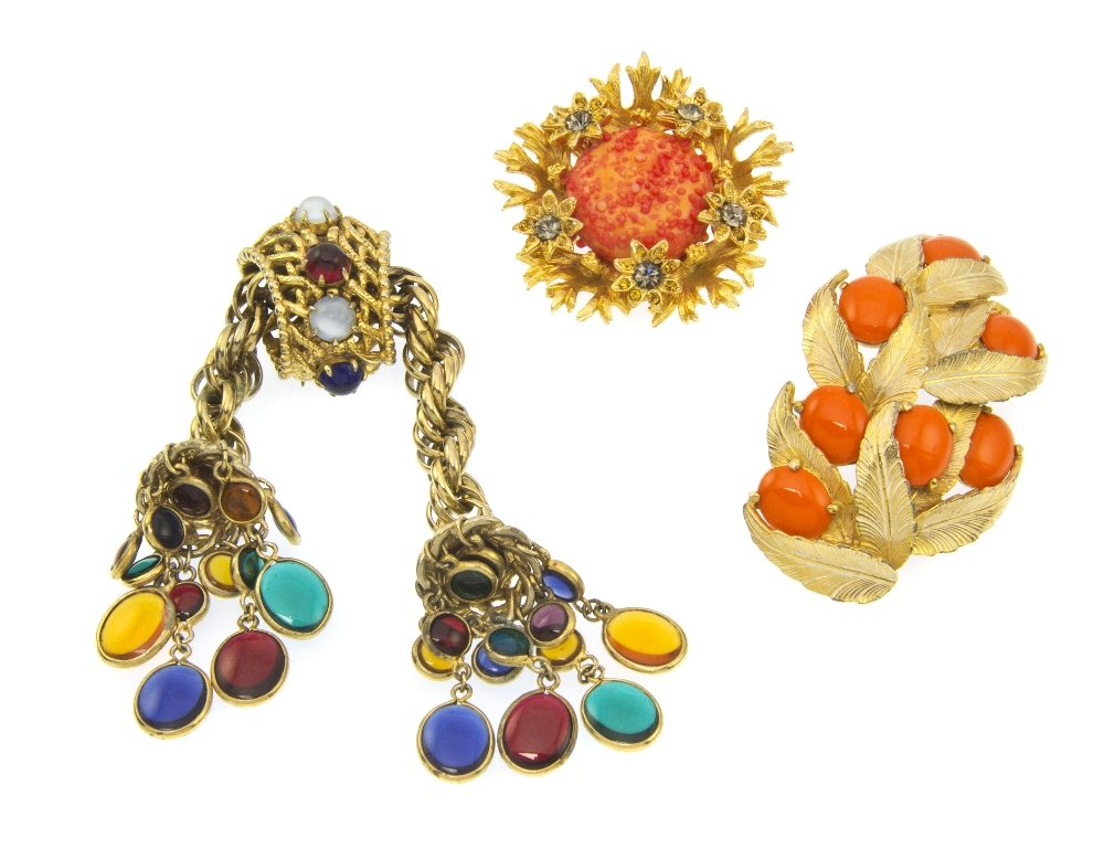 A Group of Three Elsa Schiaparelli Brooches,: A Group of Three Elsa Schiaparelli Brooches, comprised of a multicolor resin cabochon brooch, a goldtone and bright orange resin foliate motif brooch, and a textured orange resin flower brooch. All st