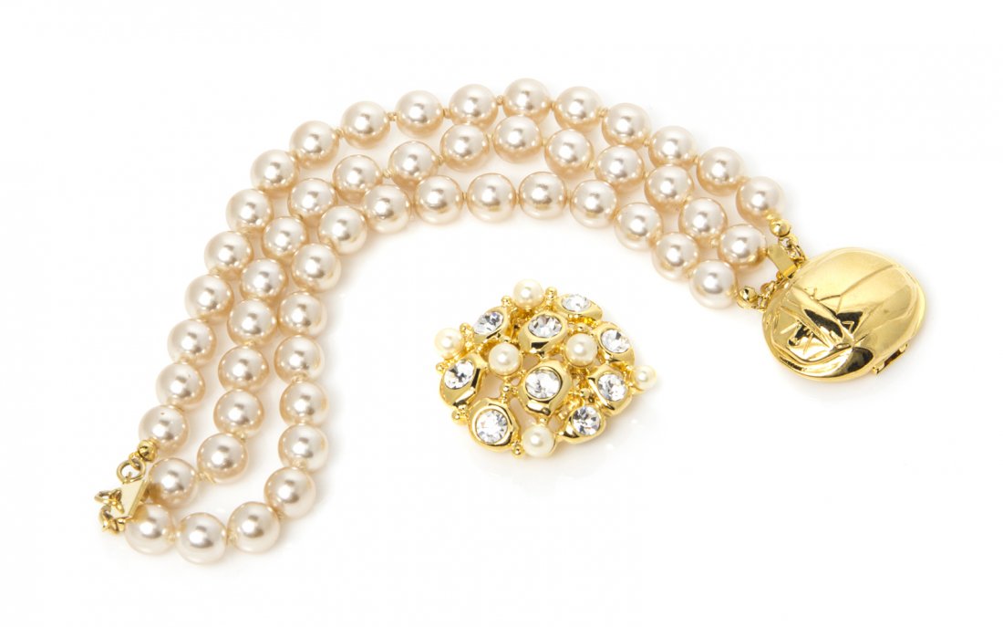 A Kenneth Jay Lane Multistrand Faux Pearl Bracelet: A Kenneth Jay Lane Multistrand Faux Pearl Bracelet, with two interchangeable clasps one in a goldtone scarab motif and one with faux pearls and rhinestones. Stamped: KJL. Property from an Important Co