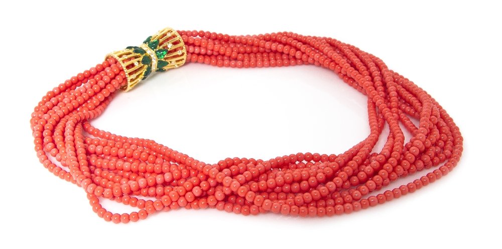 A Kenneth Jay Lane Faux Coral Torsade,: A Kenneth Jay Lane Faux Coral Torsade, from the 'Treasures of the Duchess' Collection, with green enamel and rhinestone clasp. Stamped: KJL.