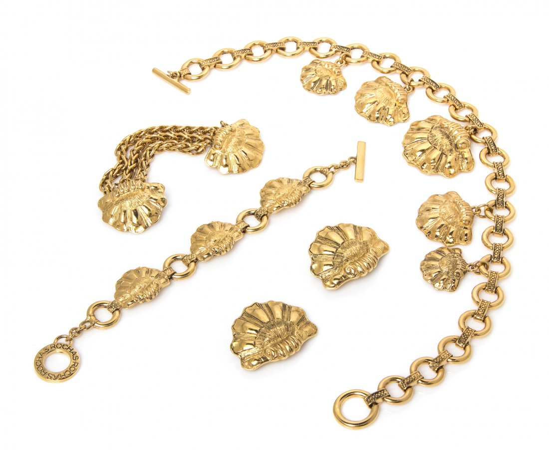 A Rochas Goldtone Shell Motif Suite,: A Rochas Goldtone Shell Motif Suite, comprised of a necklace, bracelet, brooch and earclips. Stamped: Rochas. Property from an Important Collector, Chicago, Illinois