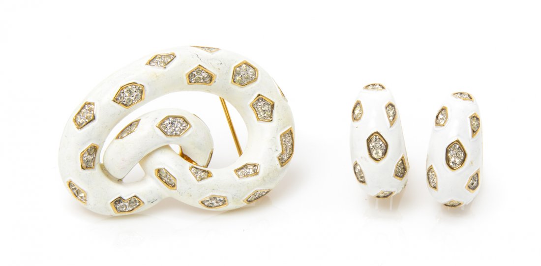 A Jomaz White Enamel and Rhinestone Suite,: A Jomaz White Enamel and Rhinestone Suite, comprised of a knot motif brooch and crescent earclips. Stamped: Jomaz. Property from an Important Collector, Chicago, Illinois