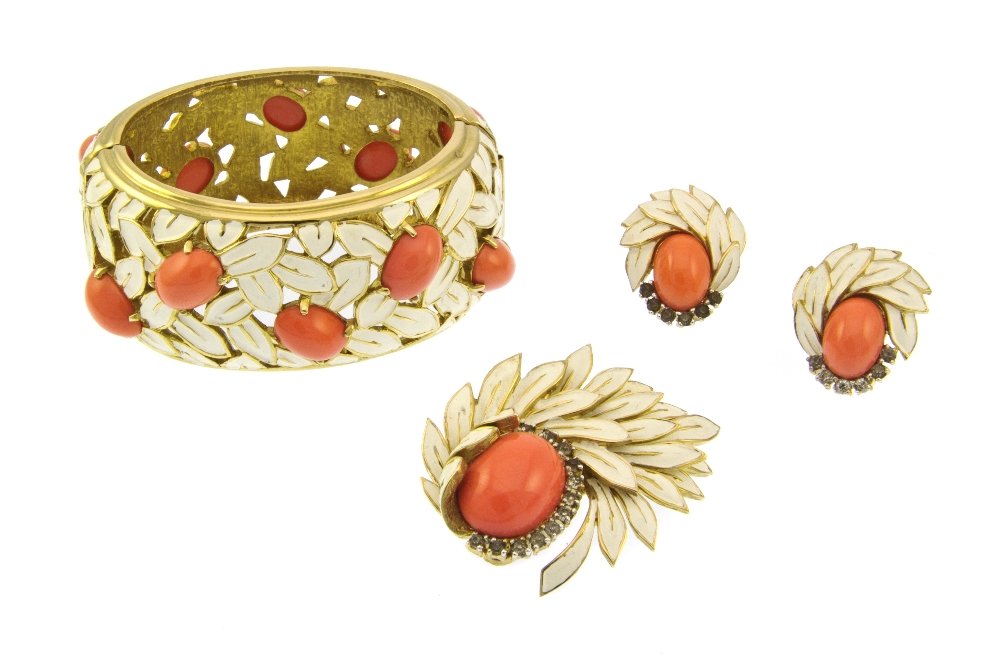 A Jomaz Cream Enamel and Faux Coral Suite,: A Jomaz Cream Enamel and Faux Coral Suite, comprised of a wide hinged cuff bracelet, a brooch and earclips in a foliate motif. Stamped: Jomaz. Property from an Important Collector, Chicago, Illinois