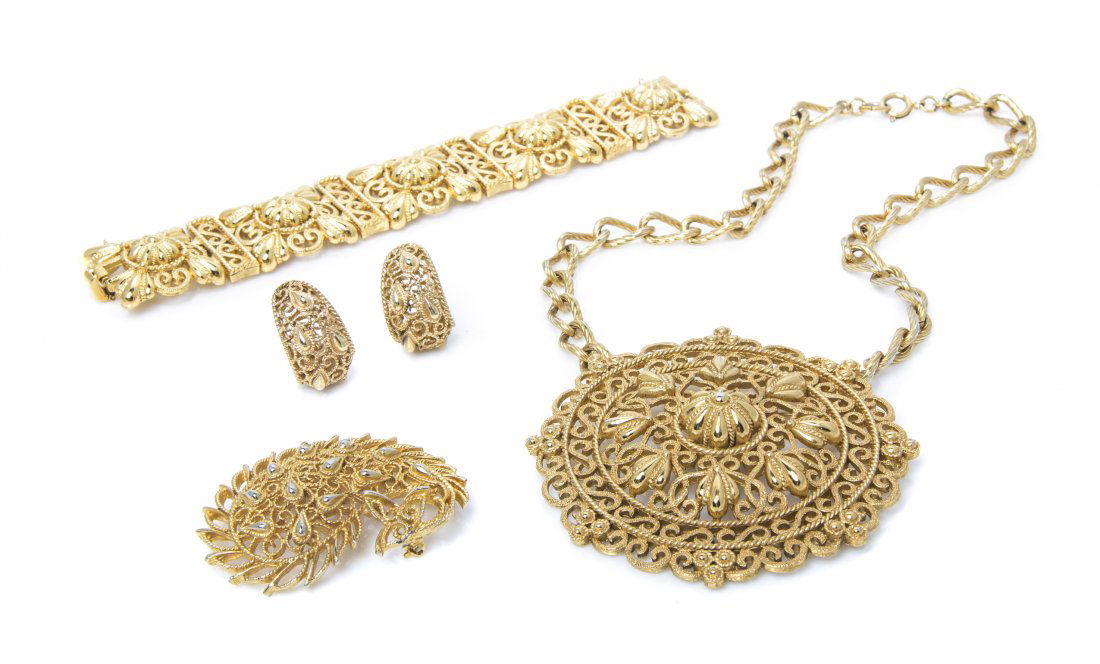 A Group of Trifari Goldtone Jewelry,: A Group of Trifari Goldtone Jewelry, comprised of a paisley motif brooch and earclips together with a scroll motif pendant necklace and bracelet. Stamped: Trifari. Property from an Important Collector