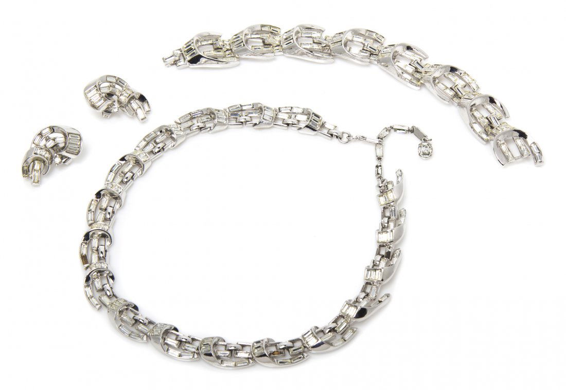 A Trifari Rhinestone Suite,: A Trifari Rhinestone Suite, circa 1950, comprised of a necklace, bracelet and earclips. Stamped: Trifari.