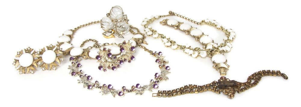 A Group of Costume Jewelry,: A Group of Costume Jewelry, consisting of a Mazer fruit salad fur clip, a Sarah Coventry 'Snow Princess' demi parure, an amber rhinestone bracelet, a Kramer white carved foliate motif necklace, and a