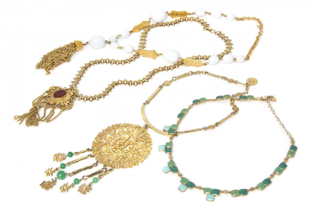 A Group of Four Goldtone Necklaces,: A Group of Four Goldtone Necklaces, comprised of a white bead and goldtone tassel pendant necklace, an LC goldtone and green enamel necklace, a goldtone Chinese character pendant with faux jade tassel