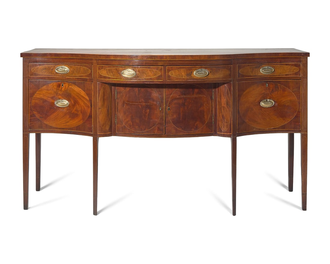 A Federal Inlaid and Figured Mahogany Serpentine Front Sideboard, New York, NY, Circa 1800: A Federal Inlaid and Figured Mahogany Serpentine Front Sideboard, New York, NY, Circa 1800 Retains original brass hardware. H: 40 in. W: 72 1/2 in. D: 26 3/4 in. This lot is located in Philadelphia. P