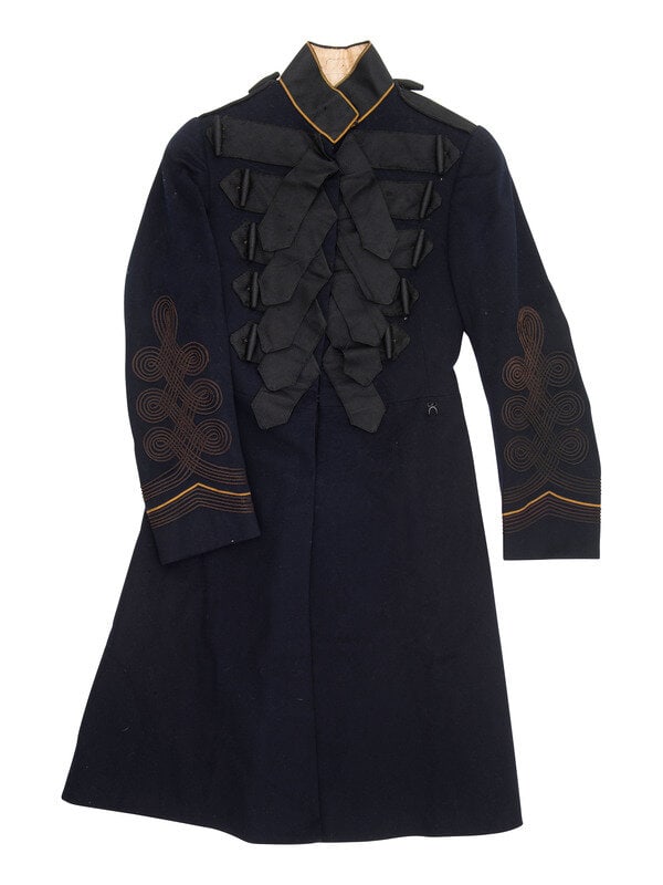 [UNIFORMS]. Repurposed military coat and trousers, ca late 1800s.: [UNIFORMS]. Repurposed military coat and trousers, ca late 1800s. Frock coat with applied yellow piping on sleeves and black ribbon on chest. Interior of stand-up collar with ink identification 