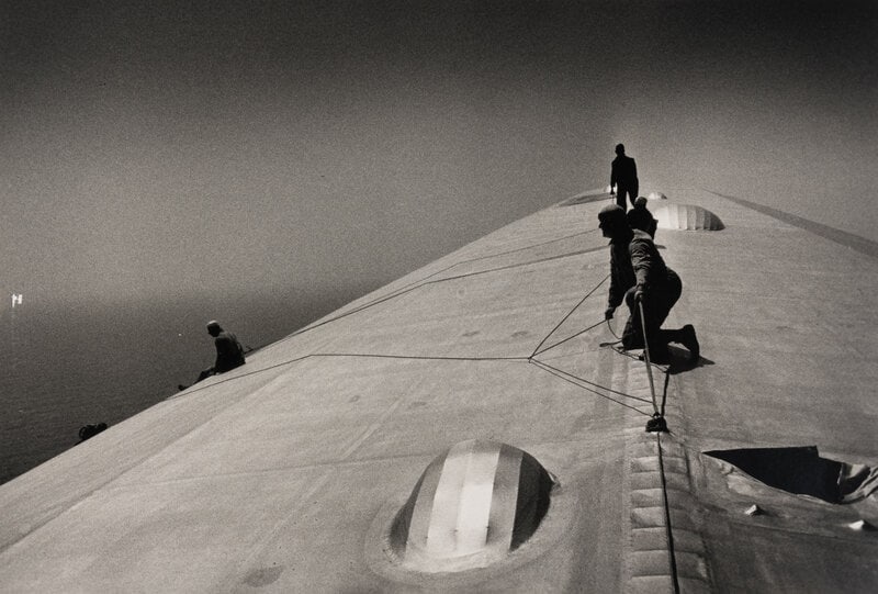 EISENSTAEDT, Alfred. Photograph of workers repairing the hull of the Graf Zeppelin during a flight o: EISENSTAEDT, Alfred (1898-1995). A photograph of workers repairing the hull of the Graf Zeppelin. EISENSTAEDT, Alfred (1898-1995), photographer. A photograph of workers repairing the hull of the Graf